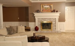 The fireplace, crown molding and other architectural details dress up this basement area. 