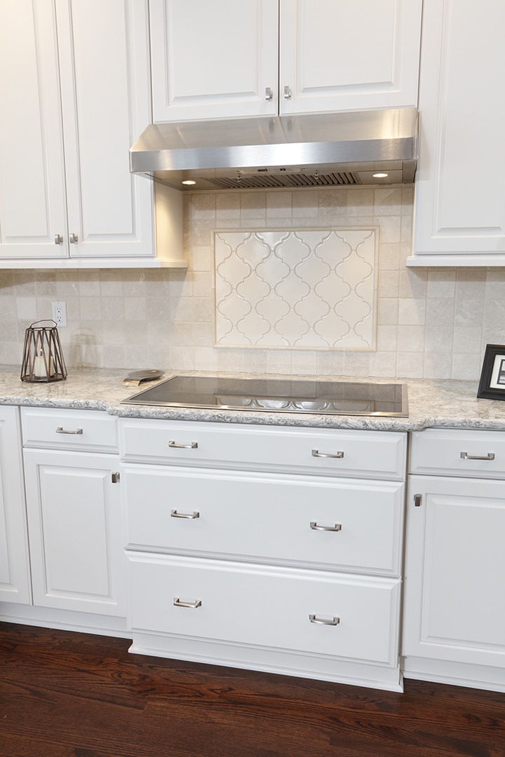 Hardwood floor creates warmth in white kitchen