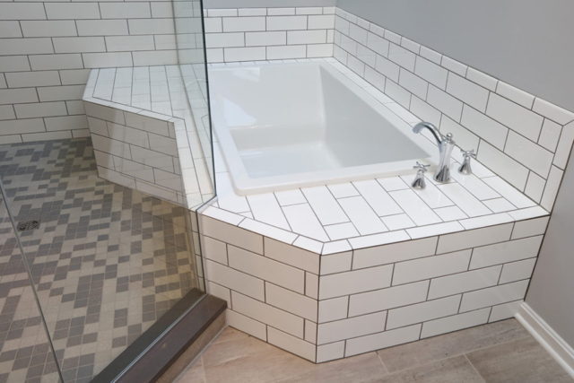 Variety of tile used in bathroom for floor, tub deck and shower enclosure