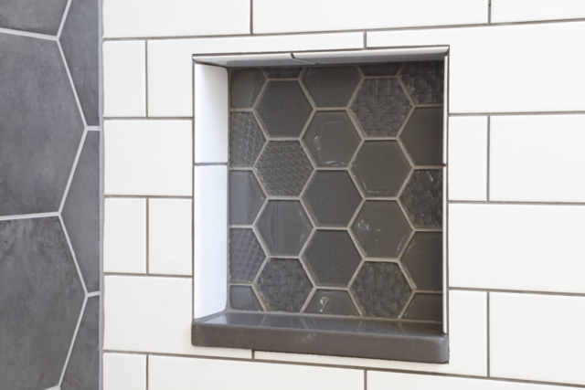 Built-in shelf in shower with hexagon glass tile