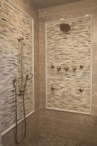 Coordinating floor, wall, ceiling and accent tiles in custom shower room