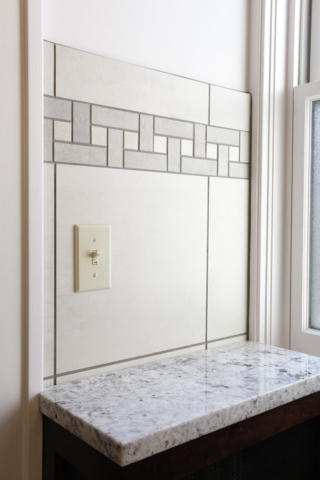 Wall tile in bathroom features accent tile inlay