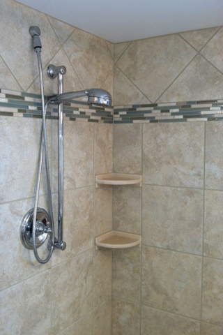 Decorative accent tile in shower enclosure