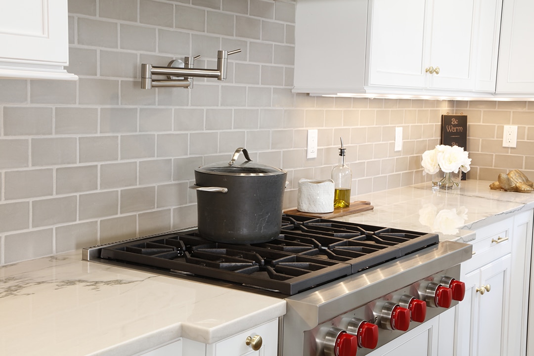 Kitchen remodel with light gray tile backsplash