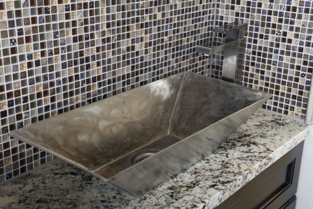Wet bar with custom  metal vessel sink and glass mosaic tile backsplash
