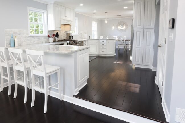 white kitchen with dark hardwood floors