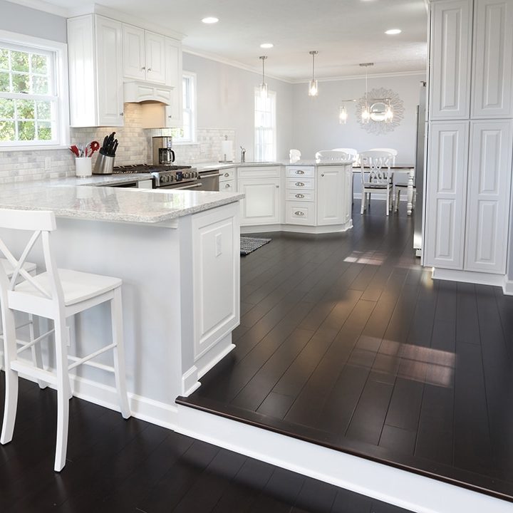 white kitchen with dark hardwood floors
