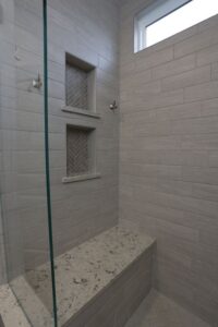 custom tile shower with niches and bench